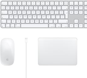 Vue d’un bureau sur lequel sont placés une Magic Mouse, un câble USB‑C, un Magic Trackpad et un Magic Keyboard avec pavé numérique